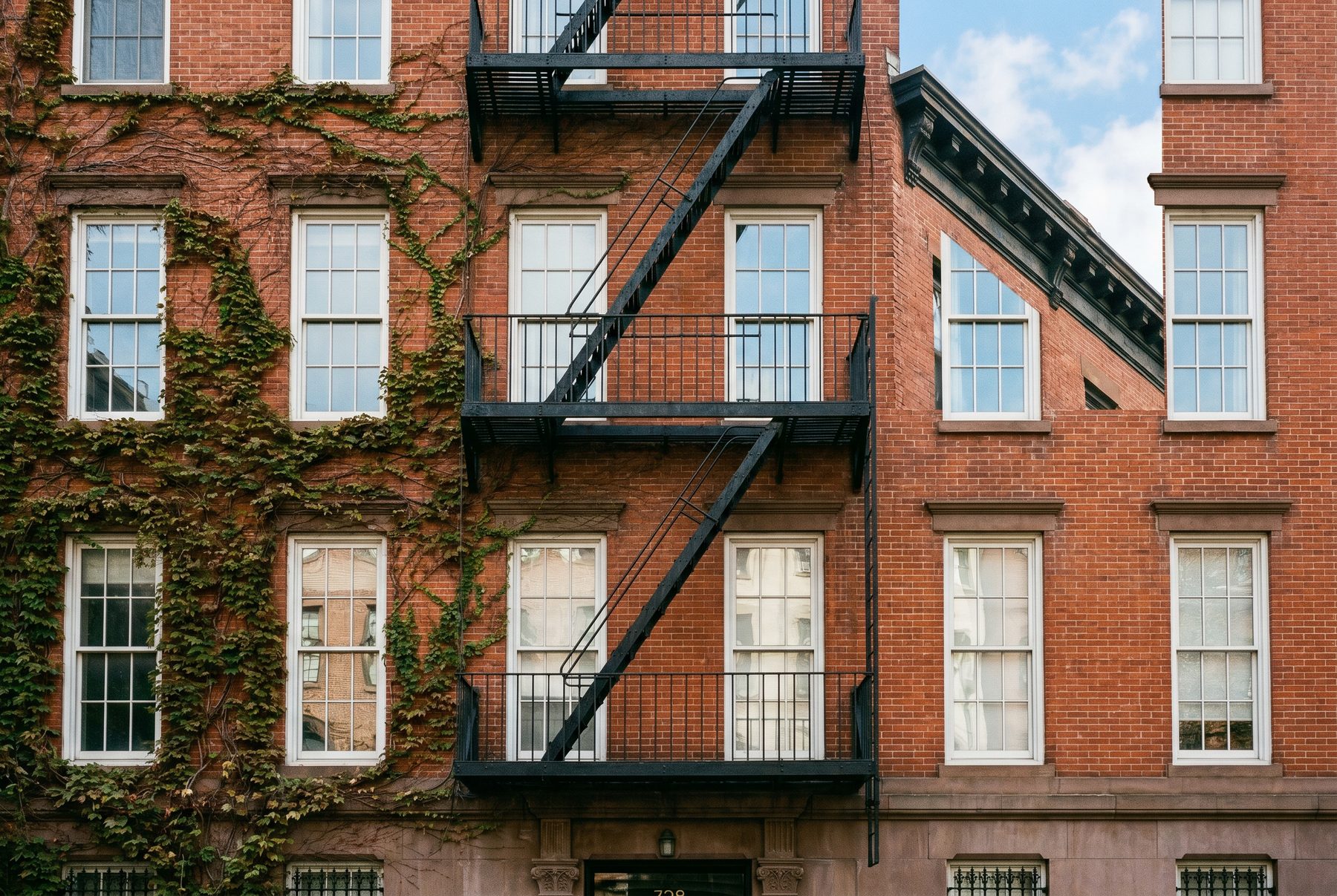 Brick apartment building with fire escapes in Chelsea, Manhattan
